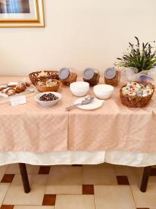 a table topped with plates and bowls of food at Hotel Villa Edelweiss in Chianciano Terme