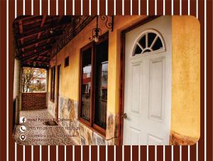 a white door on the side of a building at Hotel Posada El Camino in Chignahuapan