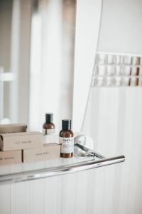 a bottle of essential oil sitting on a shelf next to boxes at Le Petit Hotel St Paul by Gray Collection in Montréal