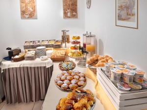 a buffet with many different types of pastries and desserts at Hotel Marisa in Riccione