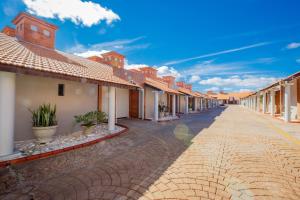 a cobblestone street with a row of houses at Motel Fascínio (Only Adults) in Cascavel