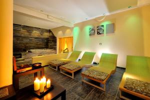 a living room with green chairs and a couch at Hotel Life in Rimini