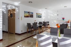 a dining room with a table and chairs at Akoja in Władysławowo
