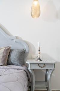 a bedroom with a bed and a table with a lamp at Smaragdi in Perivolos