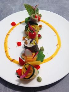 a white plate with food in the shape of a smile at Auberge de l'Arc en Ciel in Fauquembergues