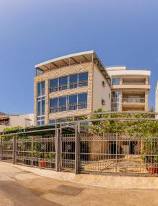 a building with a gate in front of it at ApartHotel Stijovic in Bar