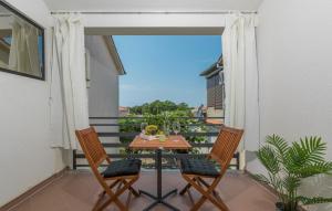 a patio with a table and two chairs on a balcony at Apartment Green with Balcony in Nova Vas