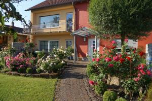 ein Haus mit Blumen davor in der Unterkunft Ferienhaus Schloss-Garten in Kapellen-Drusweiler