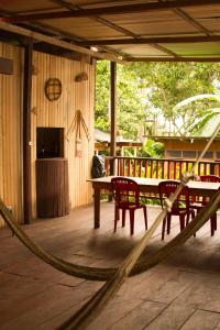 a patio with a table and chairs on a deck at La Ceiba, Amazonas in Leticia