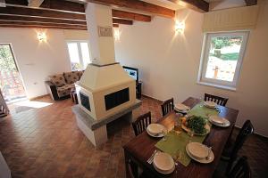 Ledenice的住宿－House Marko Breze，客厅配有桌子和壁炉