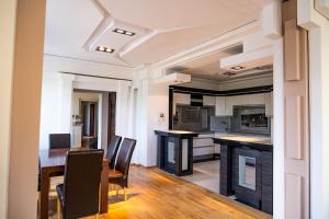 a kitchen and dining room with a table and chairs at Apartament Jeziorna in Mrągowo