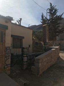 a house with a gate and a fence at El Valle in Tilcara