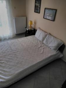 a large bed sitting in a bedroom with at Stavroula in Melissátika