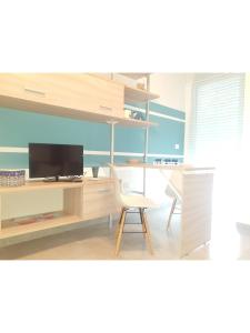 A television and/or entertainment centre at Island Apartment Porto Cesareo