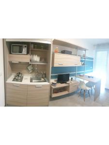 A kitchen or kitchenette at Island Apartment Porto Cesareo