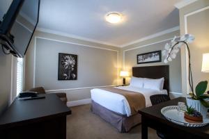 a hotel room with a bed and a desk at Regent Hotel Revelstoke in Revelstoke