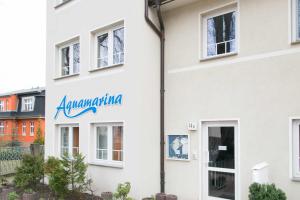 a building with aania sign on the side of it at Bansin, Aquamarina WG 10 in Bansin +16 photos