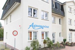 a white building with theaniaania sign on it at Bansin, Aquamarina WG 10 in Bansin