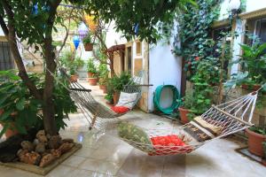 a porch with two hammocks and a tree at Sevin Hotel Pension in Bodrum City