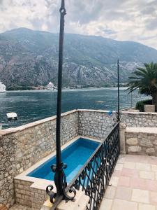 a swimming pool with a view of the water at Luxury Waterfront Villa with Private Pool and Private Beach for 12 People in Kotor