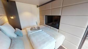 a room with two beds and a tv in it at White Pearl Apartment 2.02 in Timmendorfer Strand
