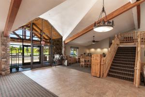 
a large room with a staircase leading to a balcony at MountainView Lodge and Suites in Bozeman
