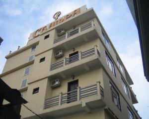 a building with a sign on top of it at Champa Hue Hotel in Hue