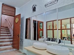 a bathroom with two sinks and a staircase at OsteL By OstiC in Bandung