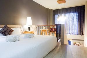 Postel nebo postele na pokoji v ubytování Hatyai Signature Hotel