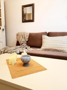 a living room with a couch and a table with candles at Emmanouil airport beach apartment in Karteros