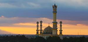 a mosque with a clock tower on top of it at Sunwood Hotel Arianz Mataram in Mataram