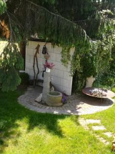 a garden with a fountain in the middle of a yard at Angel's Nest Apartment in Komenda