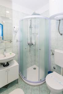 a bathroom with a shower and a toilet and a sink at MiMa's Rooms in Omiš