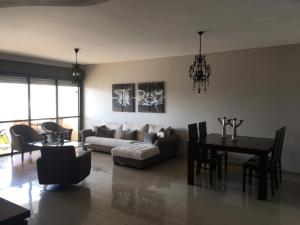 a living room with a couch and a table at Apartment 2 bedrooms Central Location in Ashdod