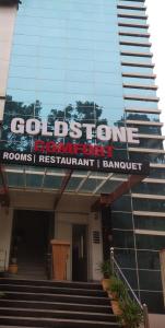 a building with a sign on the front of it at Gold Stone Comfort in Dehradun