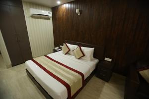 a hotel room with a bed with two pillows at Gold Stone Comfort in Dehradun