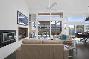 a living room with a couch and a fireplace at Bonnie's at Barwon in Barwon Heads