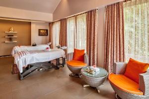 a hospital room with a bed and chairs at Mayfair Spa Resort & Casino in Gangtok