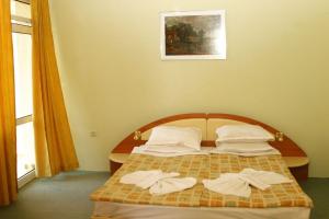 a bedroom with a bed with towels on it at Hotel Panorama in Sveti Vlas +16 photos