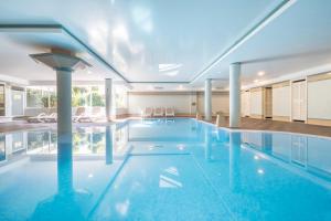a large swimming pool in a house at Tropicana Hotel in Cala Millor