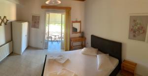 a room with a bed and a table and a refrigerator at Filoxenia Kontogiannis in Lazaráta