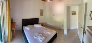a bedroom with a bed with two pillows on it at Filoxenia Kontogiannis in Lazaráta