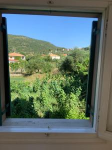 a window with a view of a field at Filoxenia Kontogiannis in Lazaráta