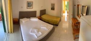 a bedroom with a bed and a tub in it at Filoxenia Kontogiannis in Lazaráta