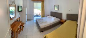 a bedroom with a bed and a tv in it at Filoxenia Kontogiannis in Lazaráta
