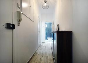 a hallway with white walls and a wooden floor at Studio Graça in Lisbon