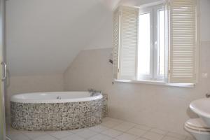 a bathroom with a tub and a sink and a window at Dom Nadmorski "Casa Azul" Gdynia Kosakowo in Mechelinki +58 photos