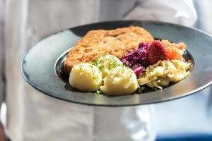 a plate of food with a salad and bread at Missterium Zakliczyn in Zakliczyn