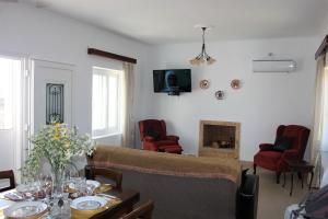 a living room with a couch and a fireplace at Evans Villa 2 in Arkasa