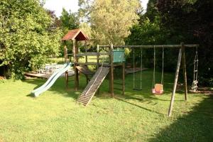 a playground with a slide and a swing set at Les Gîtes d'Olloy - Le Roi Cerf in Olloy-sur-Viroin
